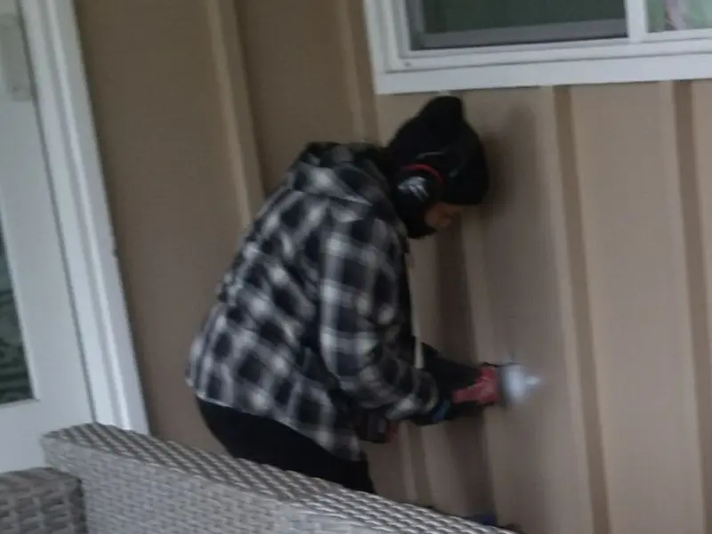 Professional electrician installing an exterior outlet in Thetford