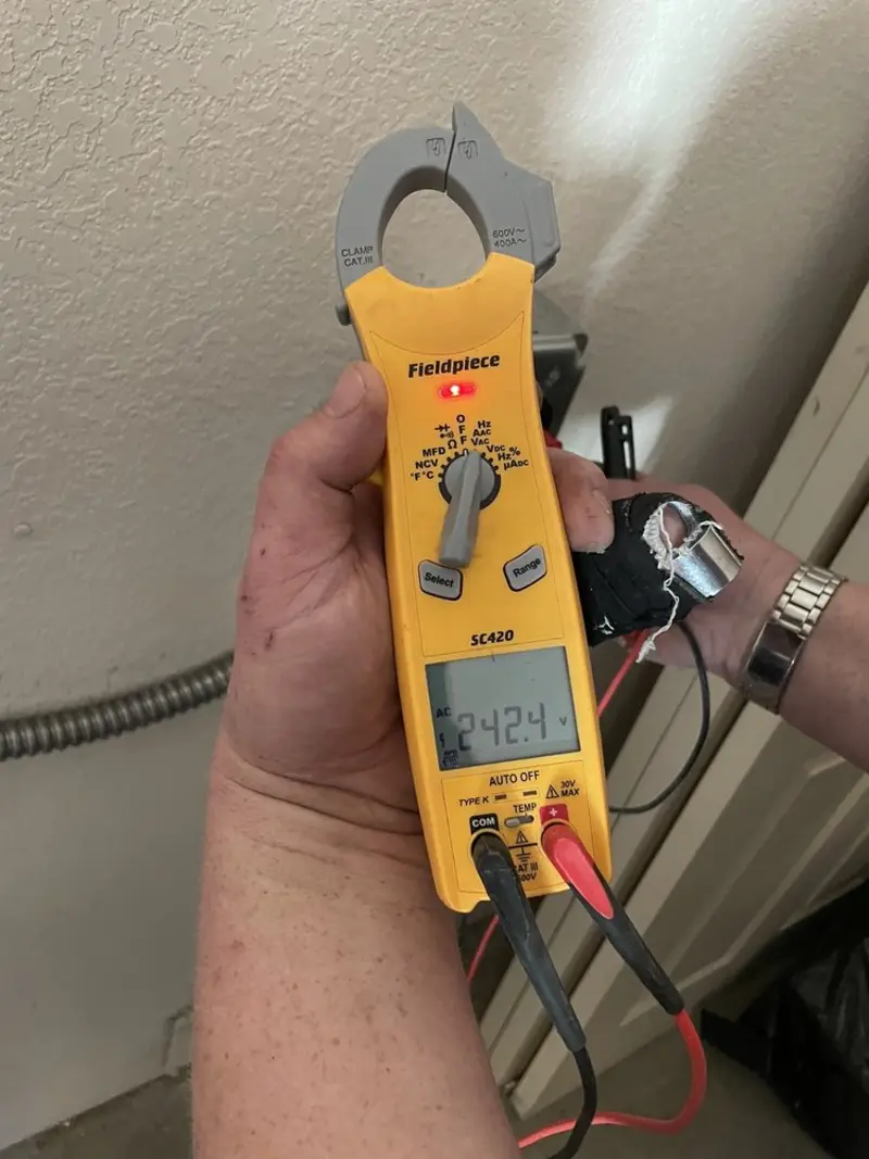 Voltage testing with clamp meter during Outlet Installation in Thetford